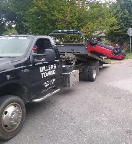 Miller’s Towing ICT accident auto recovery truck loading damaged vehicle in Wichita, Kansas