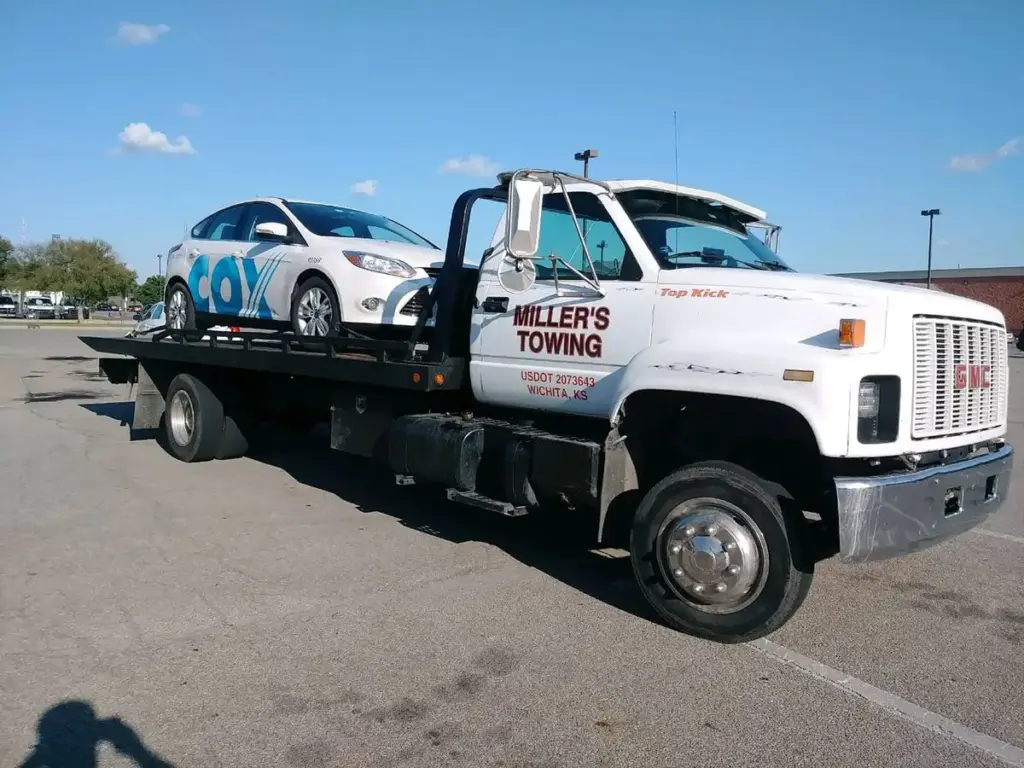 White Miller's Towing flatbed truck with USDOT number in Wichita, KS