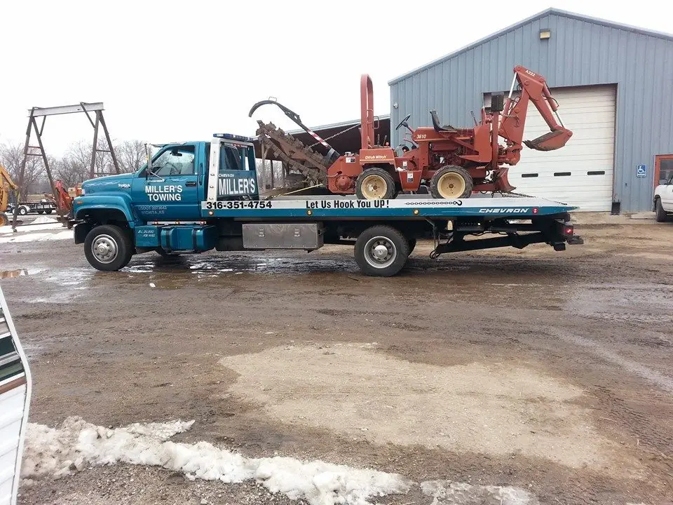 Miller's Towing flatbed transporting utility equipment in Wichita